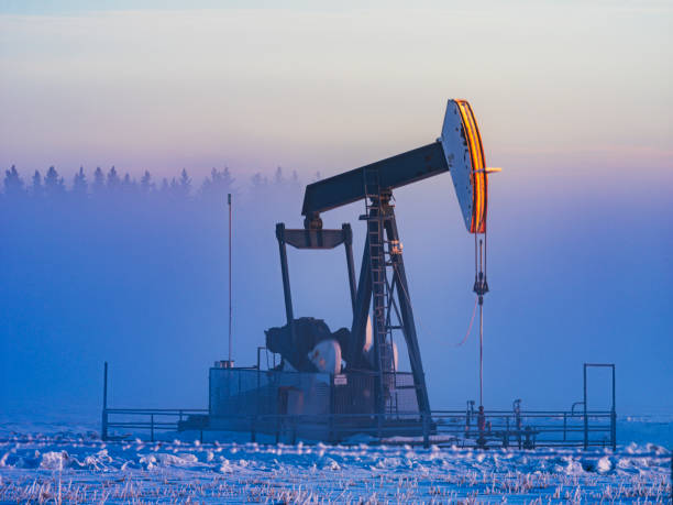 prairie morning winter oil pumping in winter morning, alberta, canada. oil  stock pictures, royalty-free photos & images