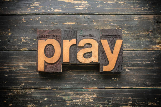 Pray Concept Vintage Wooden Letterpress Type Word The word "PRAY" written in vintage wood letterpress type on a vintage rustic background. prayer request stock pictures, royalty-free photos & images