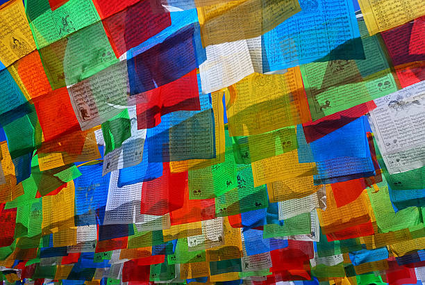 Prayer flag A prayer flag is a colorful panel of rectangular cloth, it is believed to have originated with Bonn in Tibet, traditionally they are woodblock-printed with texts and images. tibet stock pictures, royalty-free photos & images