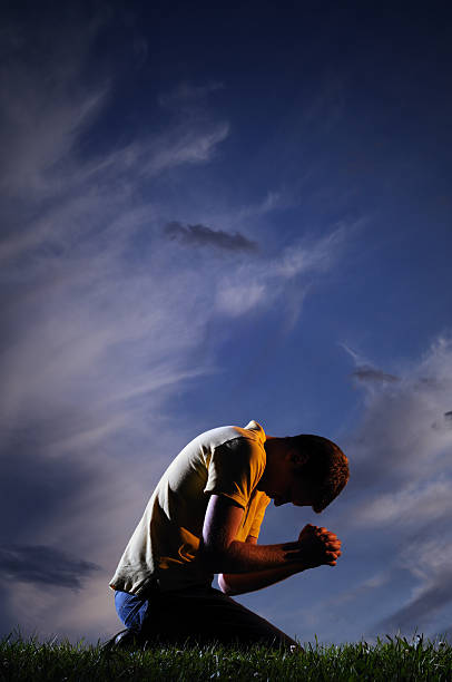 Man Praying On Knees Stock Photos Pictures And Royalty Free Images Istock