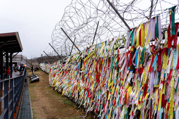 Prayer ribbons tied on the fence at Imjingak Park near DMZ in Paju, South Korea. stock photo