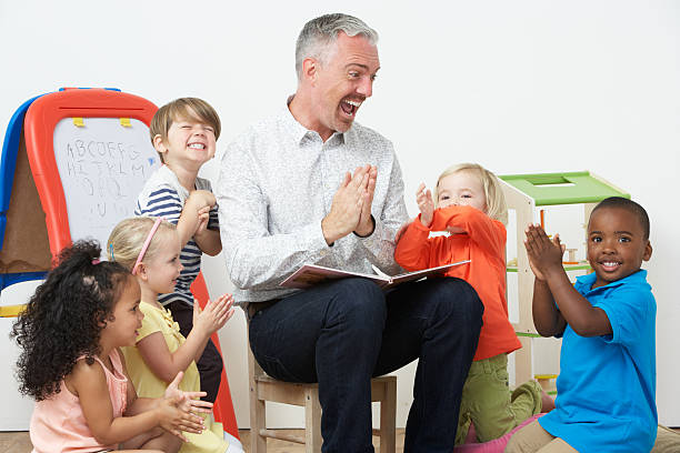 Pre School Teacher Reading Story To Children And Praying stock photo