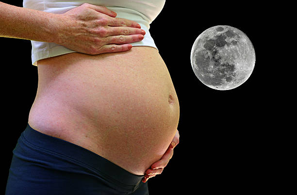 pregnancy and full moon stock photo
