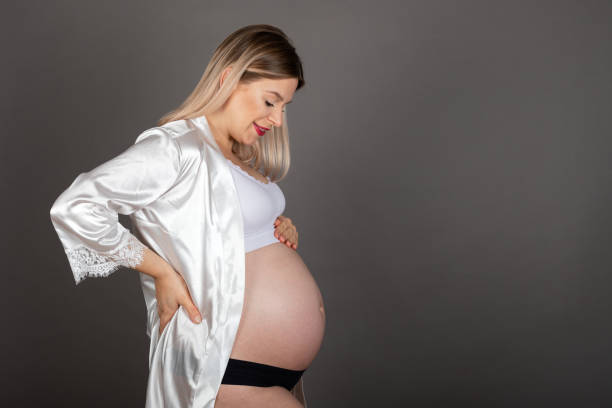 Pregnancy photography indoor stock photo