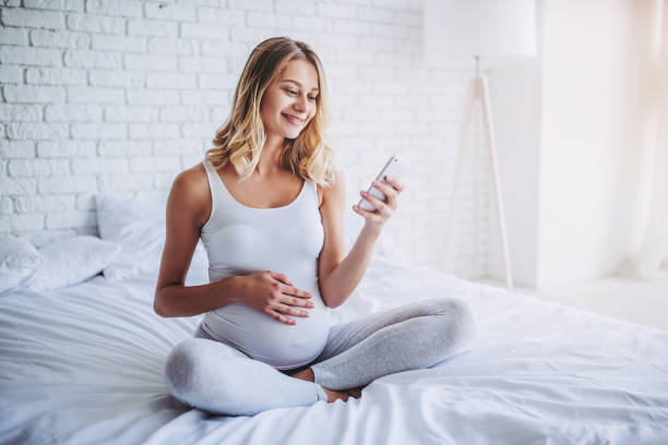 Pregnant in bed. stock photo