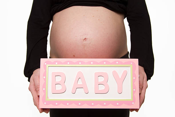 Pregnant Mother Holding Baby Box stock photo