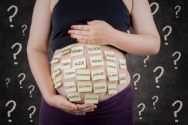 Pregnant woman finding baby names stock photo