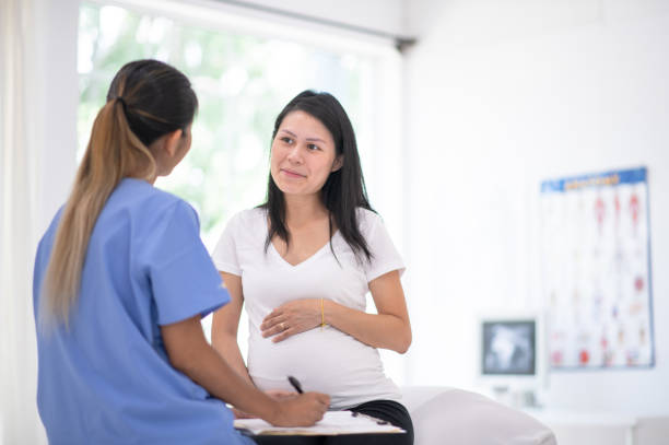 Pregnant woman goes for medical check-up stock photo