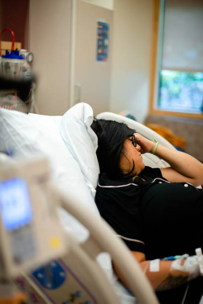 Pregnant Woman in hospital bed with painful contractions before labor stock photo