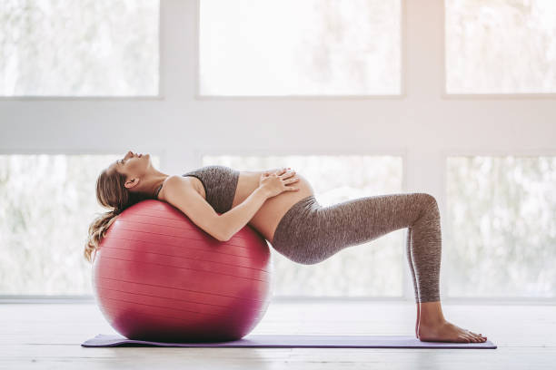 Pregnant woman workout. stock photo