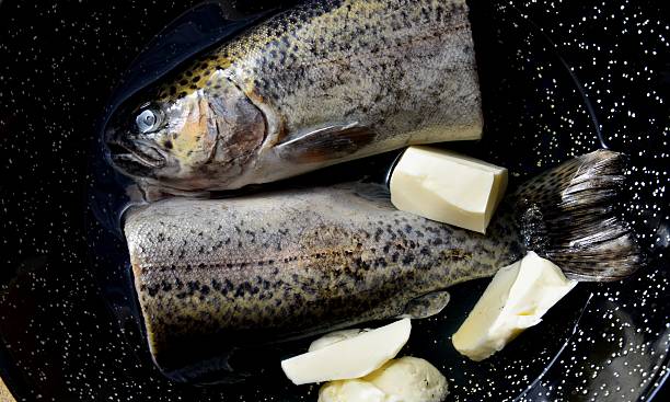 Preparation trout in white wine stock photo