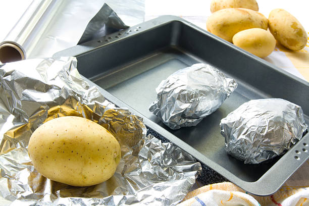Preparing baked potatoes stock photo