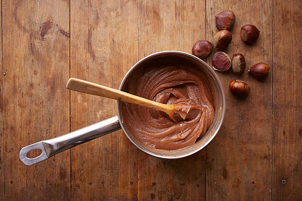 Preparing homemade chestnut cream on a pot Preparing homemade chestnut cream on a pot on wooden table overlook shot chestnut food stock pictures, royalty-free photos & images