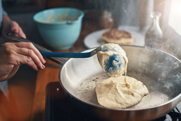 preparing pancakes with blueberries in domestic kitchen - ready mix imagens e fotografias de stock