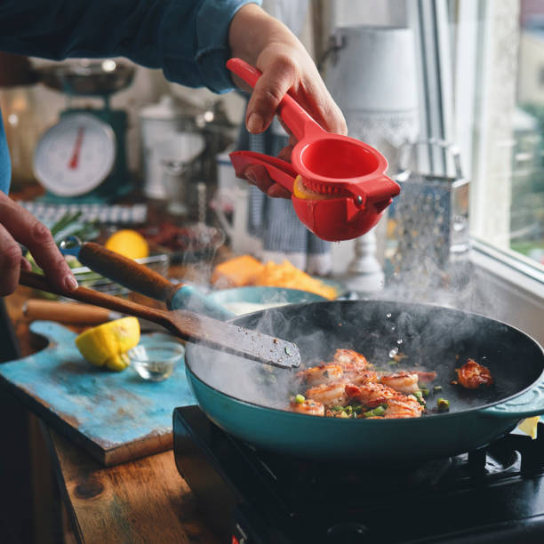 Preparing Shrimp and Grits in Domestic Kitchen stock photo