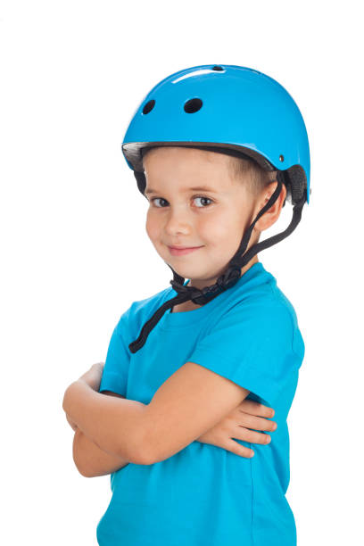 Preschool age boy 5 years old with bicycle helmet on his head, isolated on white background stock photo