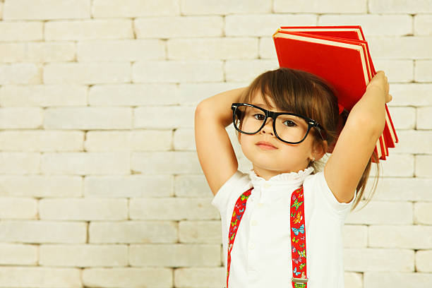 Preschooler girl with books stock photo