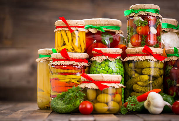 Preserved vegetables in the jars Preserved vegetables in the jars  green olives jar stock pictures, royalty-free photos & images
