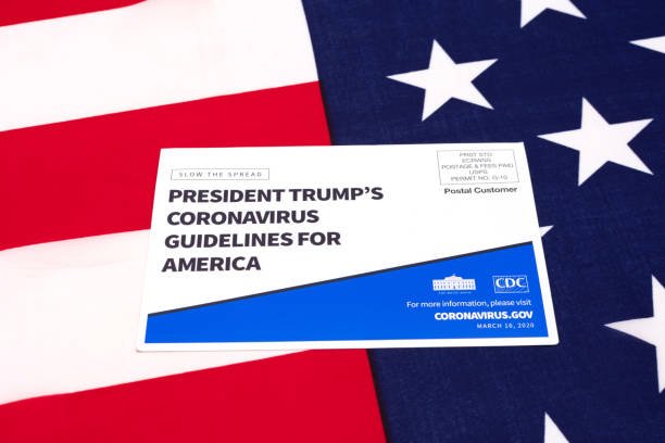 President Trump's coronavirus guidelines for America official postcardon US Flag President Trump's coronavirus guidelines for America official postcard on the flag of the United States of America - San Jose, CA, USA - March 16, 2020 donald trump stock pictures, royalty-free photos & images