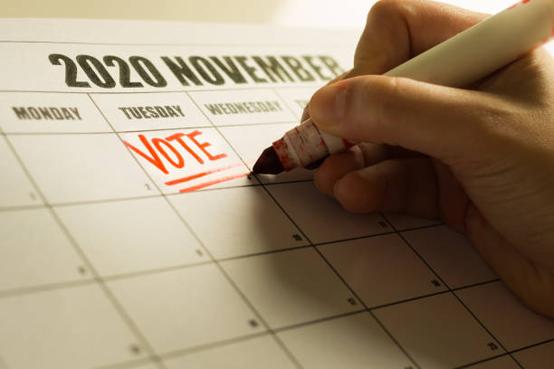 USA Presidential Vote reminder written on a 2020 November calendar. A american vote writing a reminder note on the calender to vote. election photos stock pictures, royalty-free photos & images