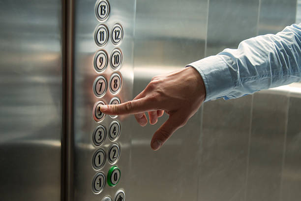 Pressing the button in the elevator stock photo
