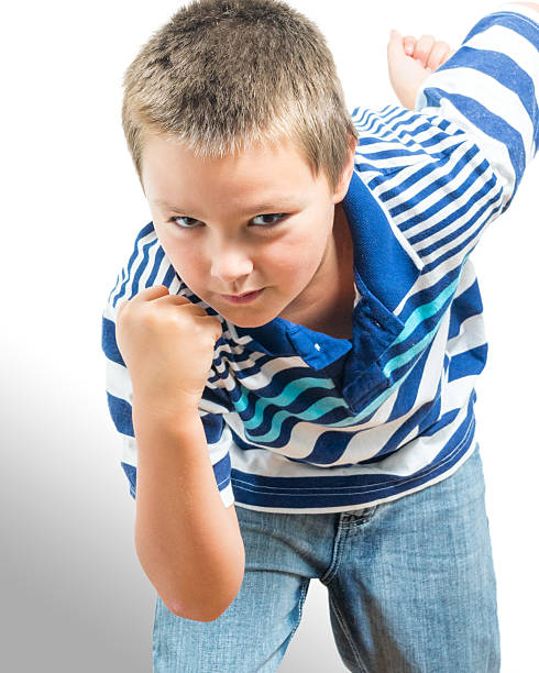Preteen Boy Flexing His Muscles Showing Strength stock photo