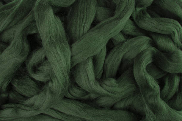 Pretty dark olive green merino wool lying in loose stings ready to be used stock photo