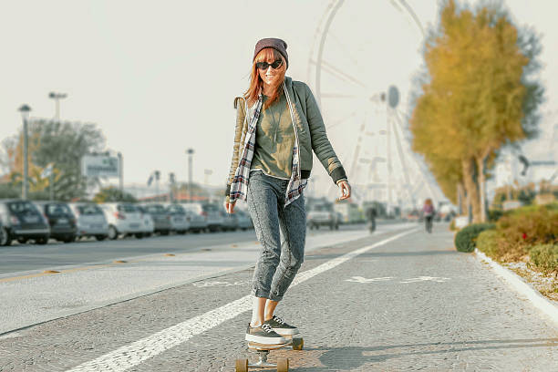 pretty girl on skateboard in action stock photo