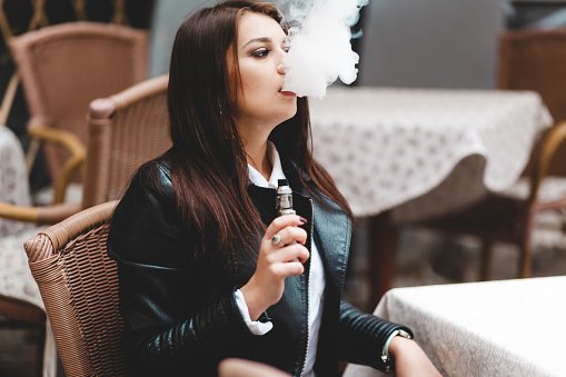 Elegant, Beautiful Woman Smoking E Cigarette Stock Photos 