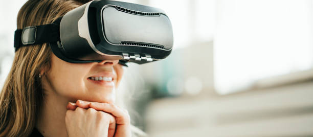 Pretty smiling woman using vr headset. Close-up stock photo