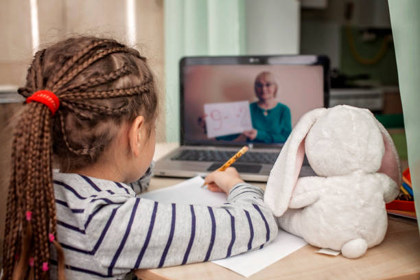 pretty stylish schoolgirl studying math during her online lesson at home, self-isolation - teacher back to school imagens e fotografias de stock