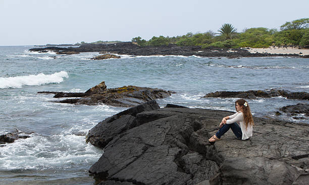 Pretty Teen Girl Meditating at Seashore Vacation of peaceful meditation in Hawaii neicebird stock pictures, royalty-free photos & images