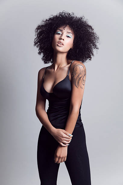 Pretty woman Portrait of a young mixed race woman woman with natural curly hair. high fashion model stock pictures, royalty-free photos & images