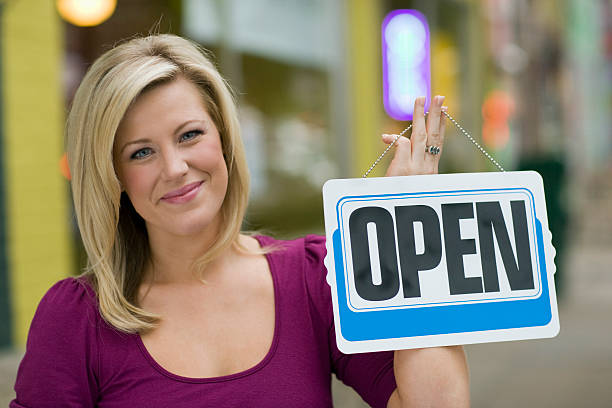 Pretty woman with open sign stock photo