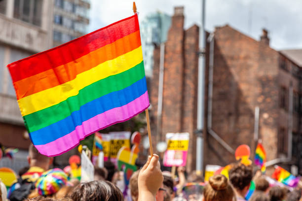 Pride Parade Flags Pride parade flags with beautiful rainbow colors lgbtqia rights stock pictures, royalty-free photos & images