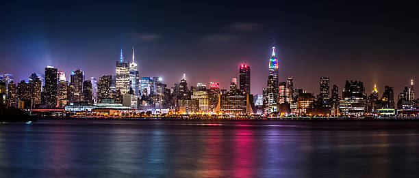 Pride Weekend Panorama Weehawken, NJ, USA - June 29, 2013: Midtown Manhattan skyline by night, during the Pride Weekend nyc pride parade stock pictures, royalty-free photos & images