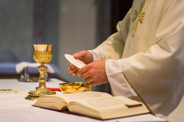 Priest during a wedding ceremony/nuptial mass Priest during a wedding ceremony/nuptial mass chalice photos stock pictures, royalty-free photos & images