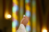 istock Priest hand holding a host in Catholic celebration 1307203471