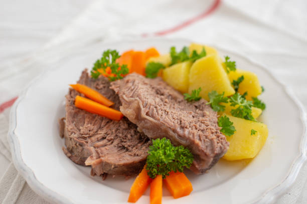 Prime boiled beef with root vegetables Prime boiled beef with root vegetables boiled stock pictures, royalty-free photos & images