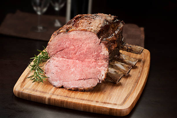 Prime rib roast on a cutting board ready to be sliced stock photo