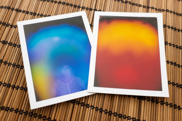 Printed aura photographs Byron Bay, Australia - November 14, 2014: Printed photos capturing a person's "aura", or the electromagnetic field that surrounds the body. The different colours are said to reveal a particular aspect of your personality. aura photos stock pictures, royalty-free photos & images