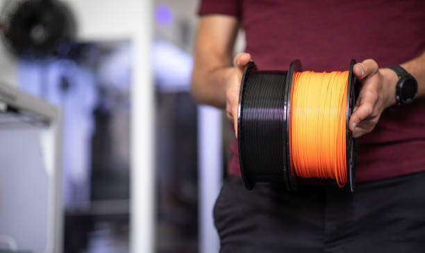 3D Printer Plastic filament for 3D printer 3D Printer Plastic filament for 3D printer and printed products in the hands of a young man light bulb filament stock pictures, royalty-free photos & images
