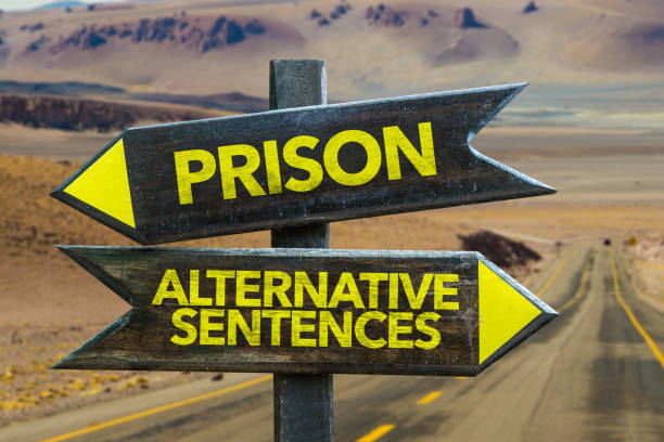 Prison vs Alternative Sentence Prison vs Alternative Sentence in a Crossroad sentencing stock pictures, royalty-free photos & images