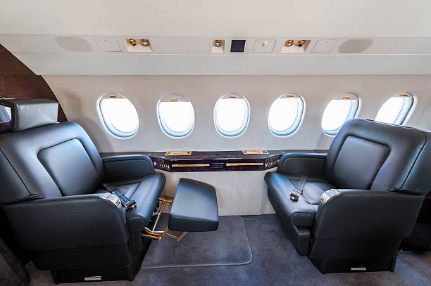 Private jet seat Side view of private airplane seat. Photo capturing comfortable and luxury interior of business class fly. plane window seat stock pictures, royalty-free photos & images