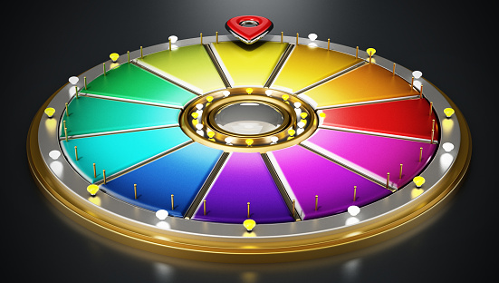 Prize wheel with blank colorful slices standing on black.