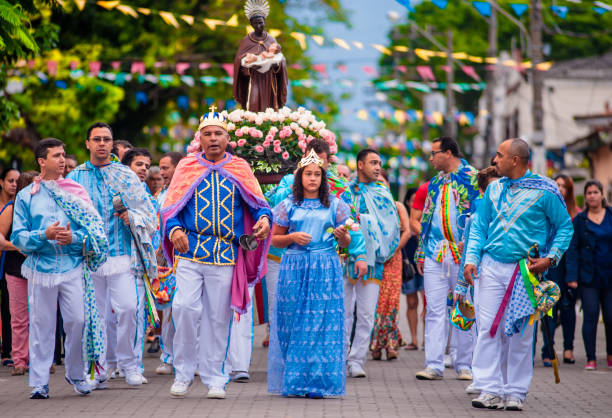 Procession of St. Benedict walking the streets of the center of the city of Ilhabela, Brazil. The event is part of the Feast of St. Benedict, traditional for more than two hundred years. The saint is led by the devotees who participate in the Congada. stock photo