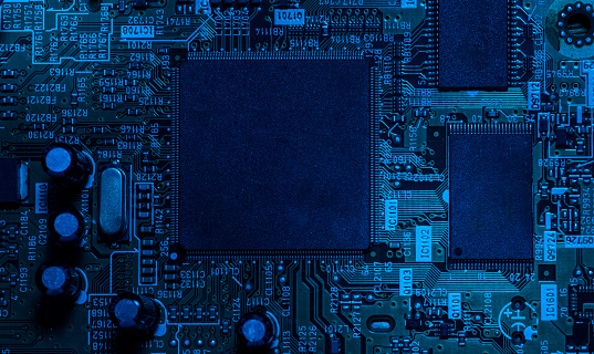 Inside of the digital electronic computer of processor chip on computer mainboard.