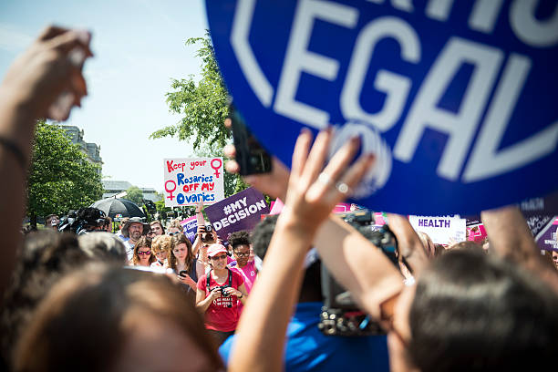 Pro-choice supporters cheering at U.S. Supreme Court Washington DC, USA - June 27, 2016: Pro-choice supporters cheer in front of the U.S. Supreme Court after the court, in a 5-3 ruling, struck down a Texas abortion access law. abortion protest stock pictures, royalty-free photos & images