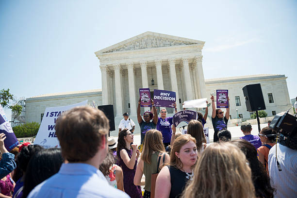 Pro-choice supporters cheering at U.S. Supreme Court Washington DC, USA - June 27, 2016: Pro-choice supporters stand in front of the U.S. Supreme Court after the court, in a 5-3 ruling in the case Whole Woman's Health v. Hellerstedt, struck down a Texas abortion access law. abortion protest stock pictures, royalty-free photos & images