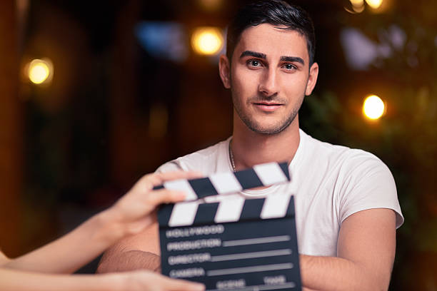Professional Actor Ready for a Shoot Portrait of a handsome man a ready to film a new scene  film slate photos stock pictures, royalty-free photos & images